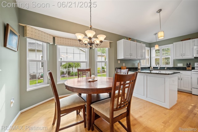 2336 Swans Cv Unit 7, Fenton, MI 48430 - dining area with a chandelier, light wood-style floors, and lofted ceiling