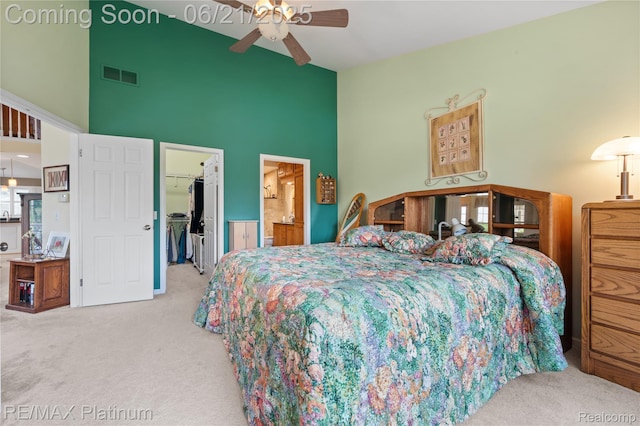 2336 Swans Cv Unit 7, Fenton, MI 48430 - carpeted bedroom featuring high vaulted ceiling, a spacious closet, ensuite bath, and ceiling fan