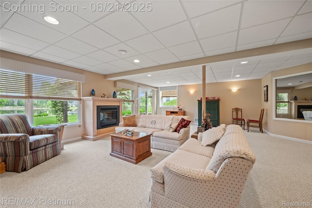 2336 Swans Cv Unit 7, Fenton, MI 48430 - living area with a glass covered fireplace, light colored carpet, healthy amount of natural light, a drop ceiling, and recessed lighting