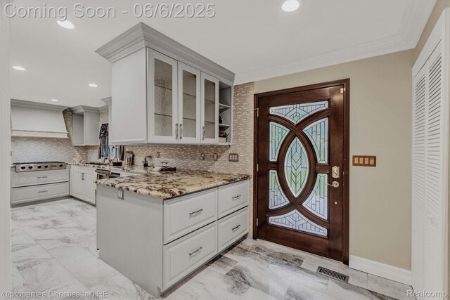 31240 Cline Dr, Beverly Hills, MI 48025 - kitchen with light stone countertops, backsplash, a peninsula, glass insert cabinets, and crown molding