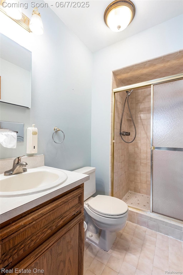16256 Karen Dr, Clinton Township, MI 48038 - bathroom featuring vanity, toilet, a stall shower, and tile patterned floors