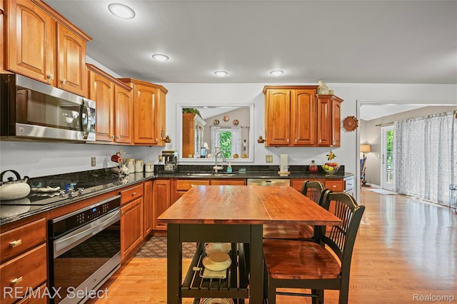 2391 Atwell Rd, Attica, MI 48412 - kitchen featuring stainless steel appliances, a sink, light wood-style flooring, wood counters, and brown cabinetry