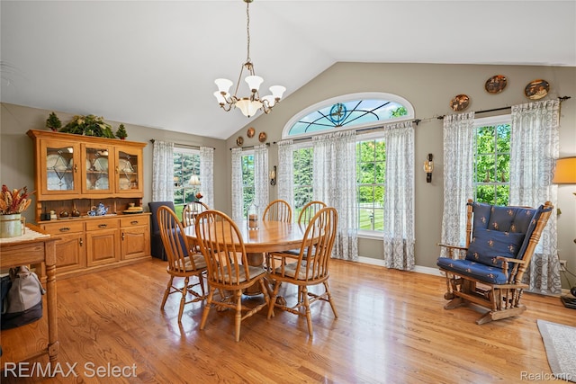 2391 Atwell Rd, Attica, MI 48412 - dining room with vaulted ceiling, a chandelier, and light wood-style flooring
