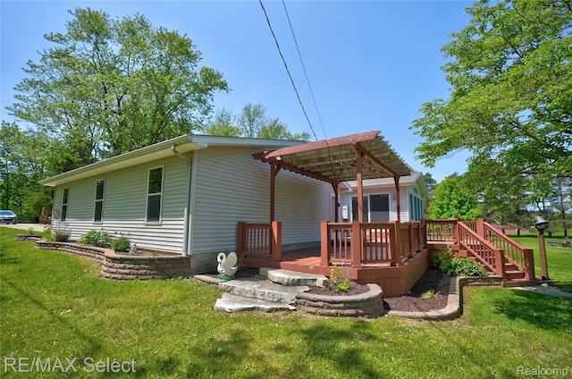 2391 Atwell Rd, Attica, MI 48412 - rear view of property featuring a lawn and a deck