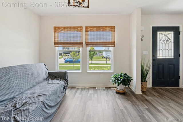 9211 Hawthorn Dr, Davison, MI 48423 - living area with wood finished floors, a chandelier, and baseboards