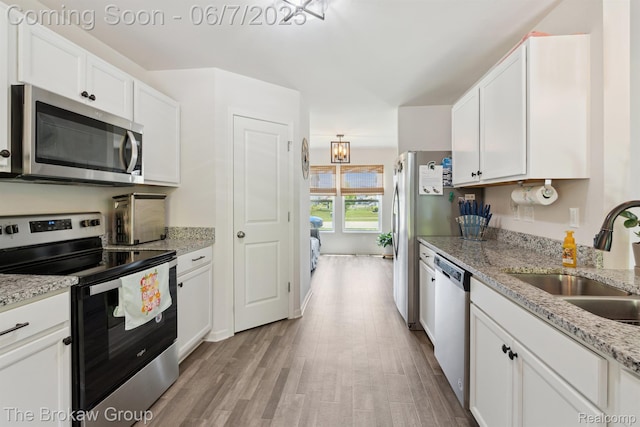 9211 Hawthorn Dr, Davison, MI 48423 - kitchen featuring appliances with stainless steel finishes, a sink, white cabinets, and wood finished floors