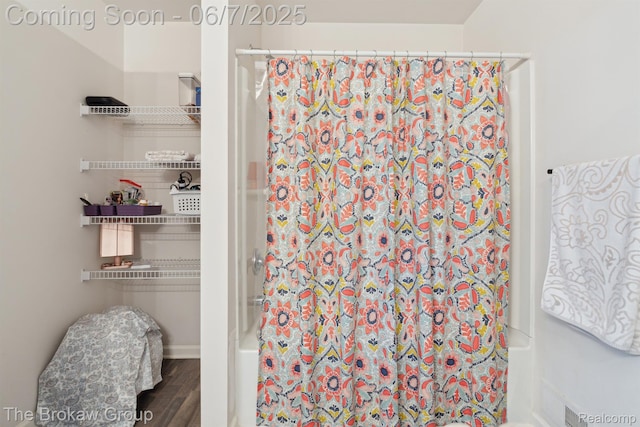 9211 Hawthorn Dr, Davison, MI 48423 - bathroom featuring shower / tub combo with curtain and wood finished floors