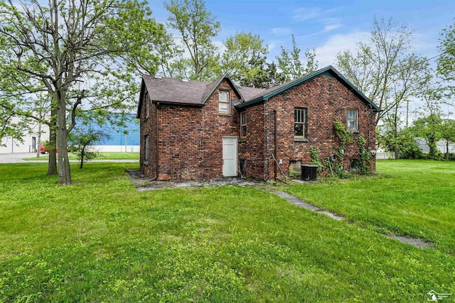 5650 Sylvia St, Dearborn Heights, MI 48125 - view of side of property with a lawn, brick siding, and roof with shingles