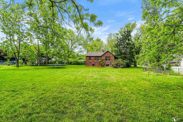 5650 Sylvia St, Dearborn Heights, MI 48125 - view of yard featuring a trampoline