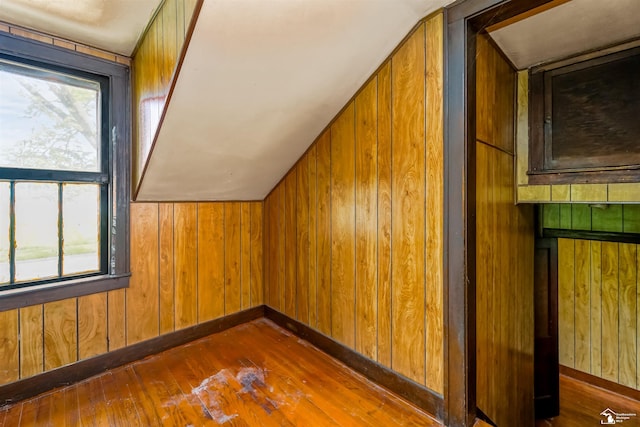 5650 Sylvia St, Dearborn Heights, MI 48125 - additional living space with healthy amount of natural light, hardwood / wood-style flooring, and wooden walls
