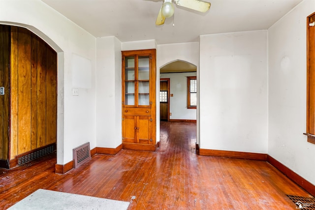 5650 Sylvia St, Dearborn Heights, MI 48125 - empty room featuring arched walkways, wood-type flooring, and ceiling fan