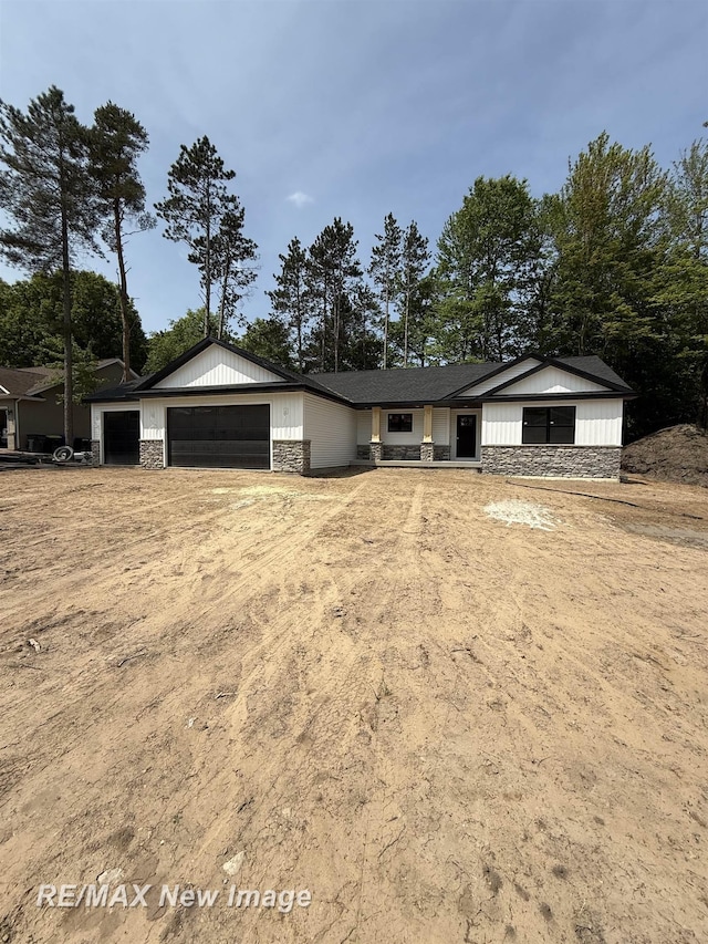 3706 Bobcat Ct, Midland, MI 48642 - view of front of home featuring stone siding and a garage