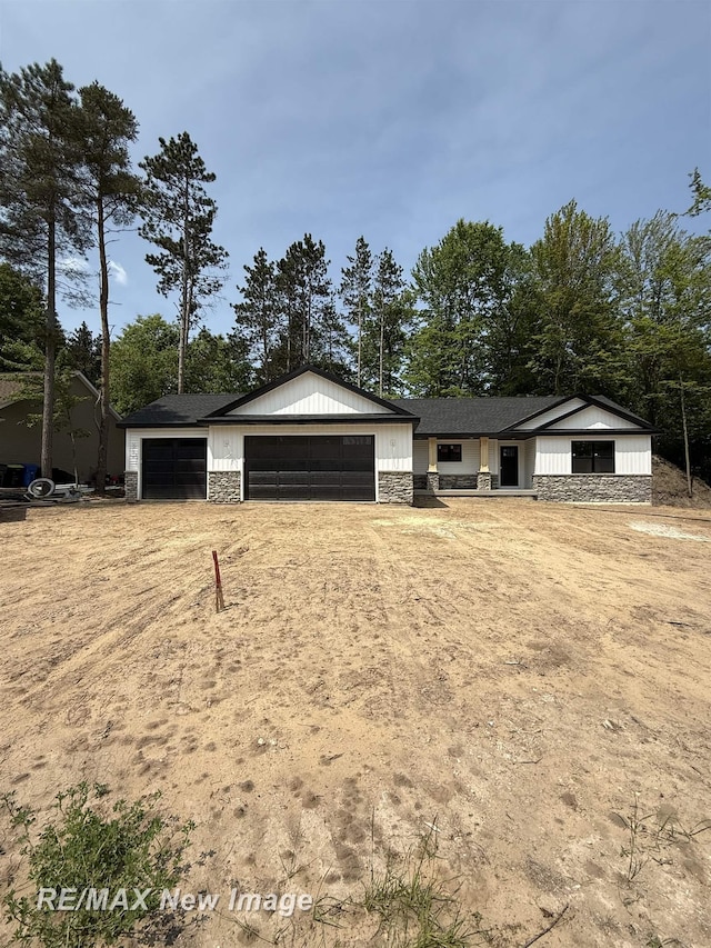3706 Bobcat Ct, Midland, MI 48642 - view of front of house featuring stone siding and a garage