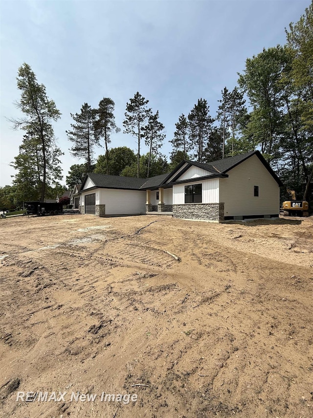 3706 Bobcat Ct, Midland, MI 48642 - view of front of property with a garage and board and batten siding