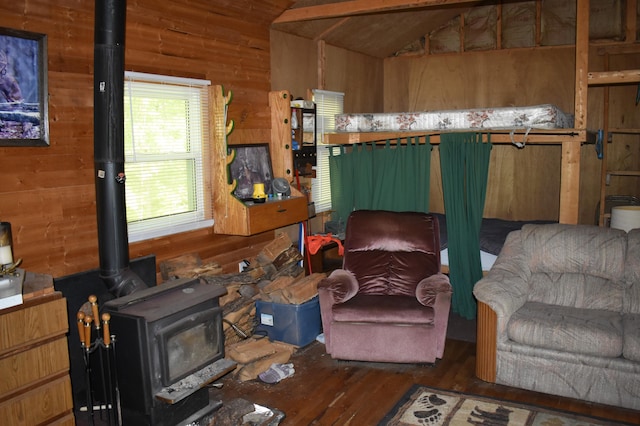 2186 88th St, Bitely, MI 49309 - living area featuring a wood stove, vaulted ceiling, wooden walls, and hardwood / wood-style floors