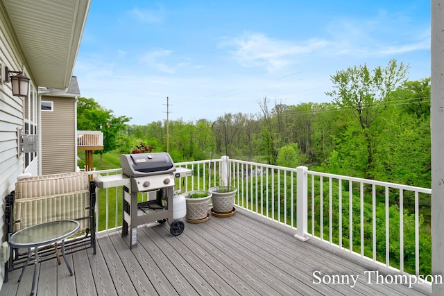 3912 Preserve Dr NE Unit 44, Belmont, MI 49306 - wooden deck featuring a grill and a forest view