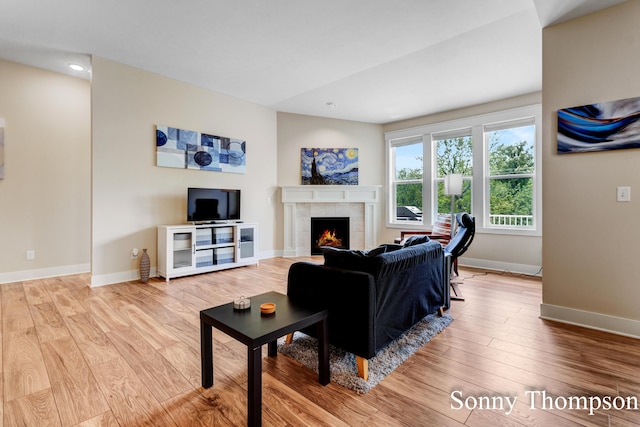 3912 Preserve Dr NE Unit 44, Belmont, MI 49306 - living area with a tile fireplace, wood finished floors, baseboards, and recessed lighting