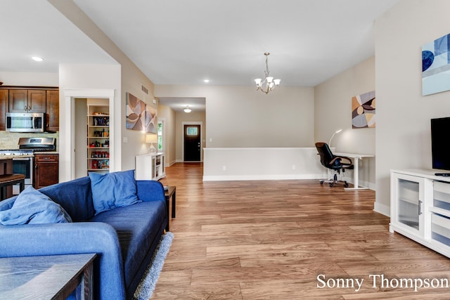 3912 Preserve Dr NE Unit 44, Belmont, MI 49306 - living room featuring light wood-type flooring, a chandelier, recessed lighting, and baseboards