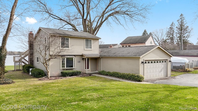 3501 Mann Rd, Clarkston, MI 48346 - view of front of property featuring a garage, driveway, and a chimney