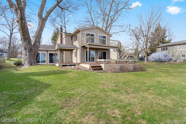 3501 Mann Rd, Clarkston, MI 48346 - rear view of house with a wooden deck, a chimney, and a yard