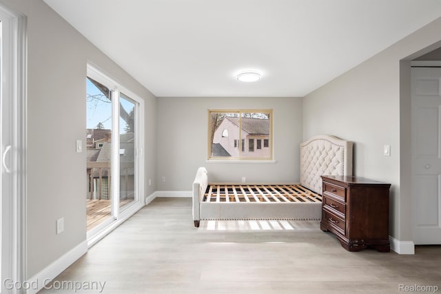 3501 Mann Rd, Clarkston, MI 48346 - bedroom featuring access to outside, wood finished floors, and baseboards