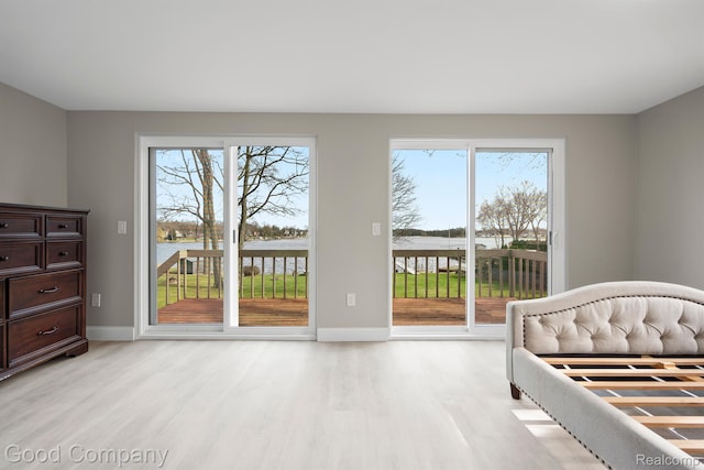 3501 Mann Rd, Clarkston, MI 48346 - bedroom with light wood-style flooring, access to exterior, baseboards, and a water view