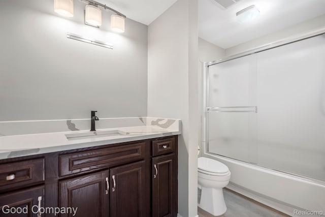3501 Mann Rd, Clarkston, MI 48346 - bathroom featuring toilet, vanity, shower / bath combination with glass door, and wood finished floors
