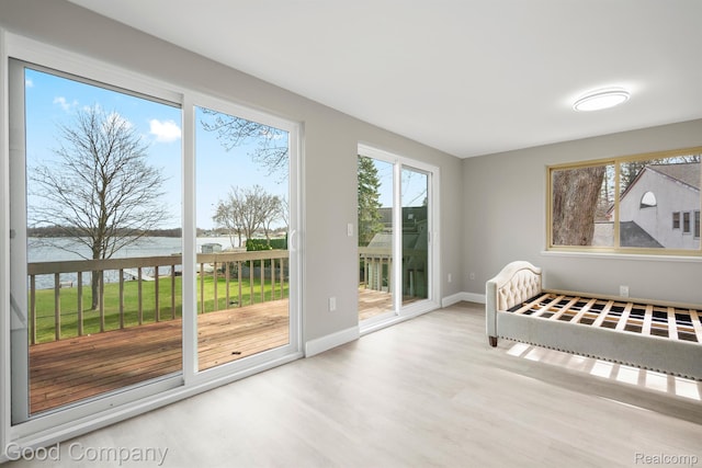 3501 Mann Rd, Clarkston, MI 48346 - unfurnished bedroom featuring access to outside, wood finished floors, a water view, and baseboards