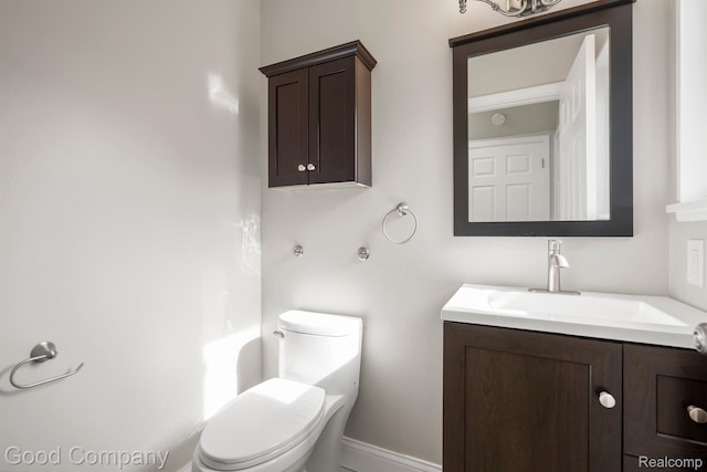 3501 Mann Rd, Clarkston, MI 48346 - half bath with vanity, toilet, and baseboards