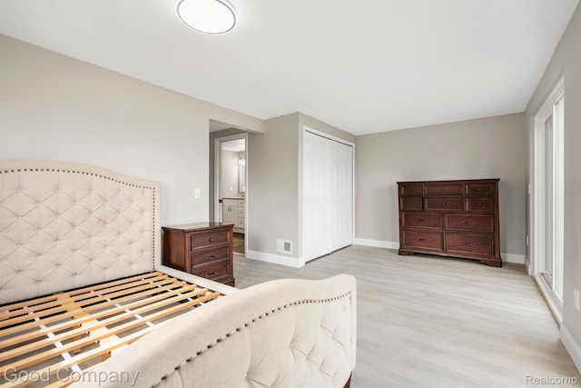 3501 Mann Rd, Clarkston, MI 48346 - bedroom featuring light wood-style flooring, a closet, and baseboards