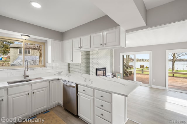 3501 Mann Rd, Clarkston, MI 48346 - kitchen featuring a sink, stainless steel dishwasher, a peninsula, white cabinetry, and recessed lighting
