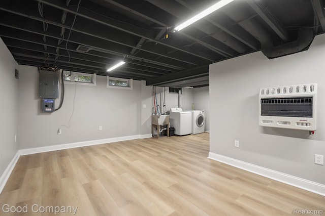 3501 Mann Rd, Clarkston, MI 48346 - basement with washing machine and dryer, heating unit, electric panel, baseboards, and wood finished floors
