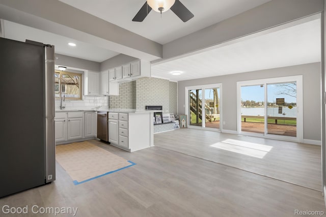 3501 Mann Rd, Clarkston, MI 48346 - kitchen with appliances with stainless steel finishes, open floor plan, light countertops, healthy amount of natural light, and recessed lighting