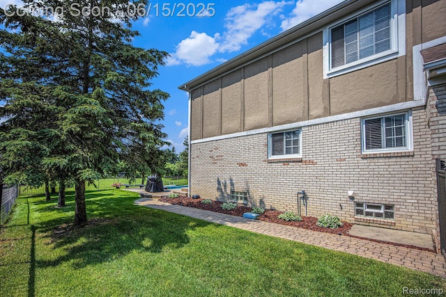 16096 Violet Dr, Macomb, MI 48042 - view of home's exterior featuring a lawn and brick siding