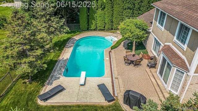 16096 Violet Dr, Macomb, MI 48042 - view of pool featuring a diving board, area for grilling, a patio, and a fenced backyard