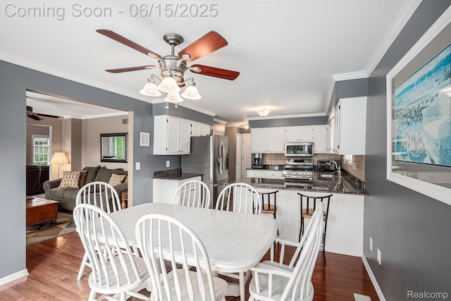16096 Violet Dr, Macomb, MI 48042 - dining room featuring a ceiling fan, crown molding, and wood finished floors