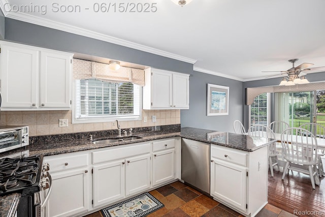 16096 Violet Dr, Macomb, MI 48042 - kitchen featuring stainless steel appliances, a peninsula, white cabinets, tasteful backsplash, and dark stone counters
