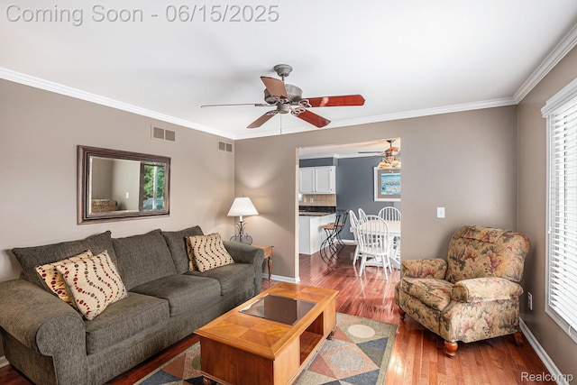 16096 Violet Dr, Macomb, MI 48042 - living area with a ceiling fan, wood finished floors, crown molding, and plenty of natural light