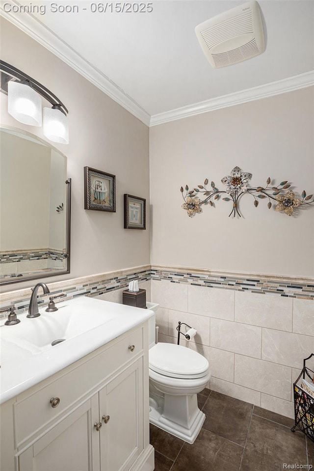 16096 Violet Dr, Macomb, MI 48042 - bathroom with tile walls, ornamental molding, vanity, tile patterned flooring, and a wainscoted wall