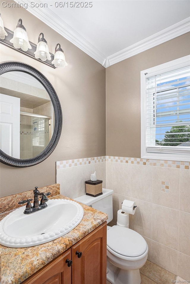 16096 Violet Dr, Macomb, MI 48042 - bathroom featuring vanity, a shower stall, tile walls, ornamental molding, and wainscoting