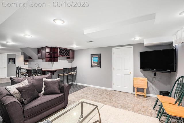 16096 Violet Dr, Macomb, MI 48042 - living room with bar with sink and baseboards