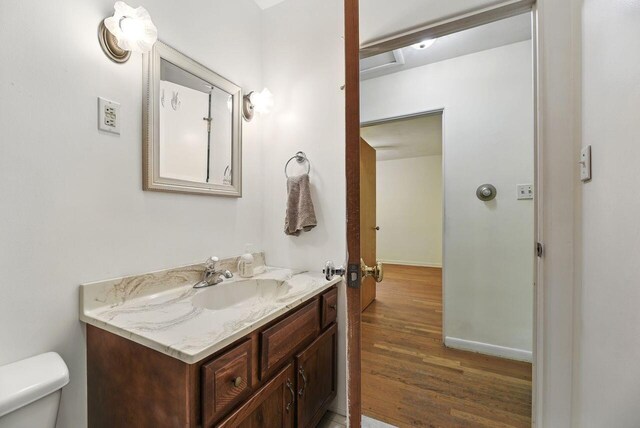 1630 S 3rd St, Niles, MI 49120 - half bath featuring vanity, wood finished floors, toilet, and baseboards