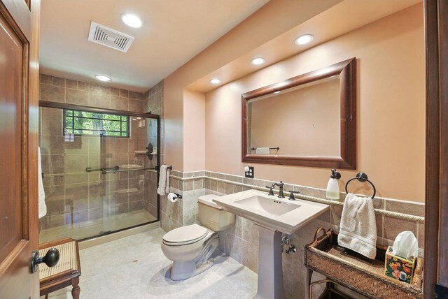 1630 S 3rd St, Niles, MI 49120 - full bathroom featuring toilet, recessed lighting, a stall shower, tile walls, and a wainscoted wall