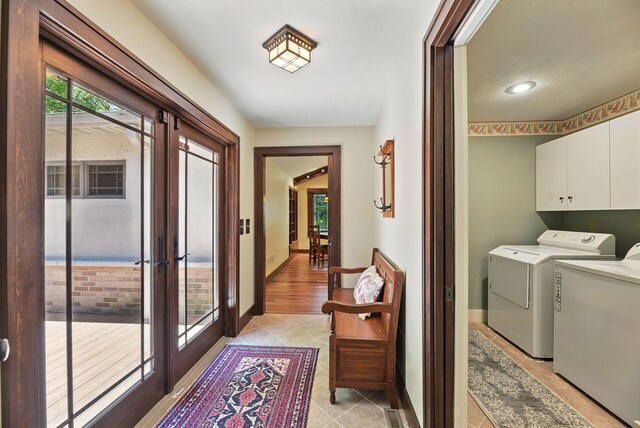 1630 S 3rd St, Niles, MI 49120 - laundry area with french doors, washing machine and clothes dryer, cabinet space, baseboards, and light tile patterned flooring