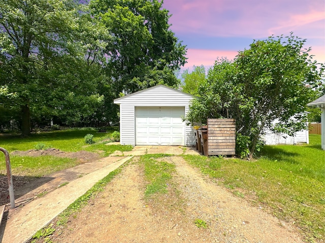 315 E Spruce St, Marshall, MI 49068 - garage at dusk featuring driveway and a garage