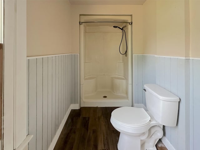 315 E Spruce St, Marshall, MI 49068 - bathroom with a stall shower, wood finished floors, a wainscoted wall, toilet, and baseboards