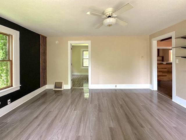 315 E Spruce St, Marshall, MI 49068 - unfurnished room featuring wood finished floors, baseboards, and ceiling fan