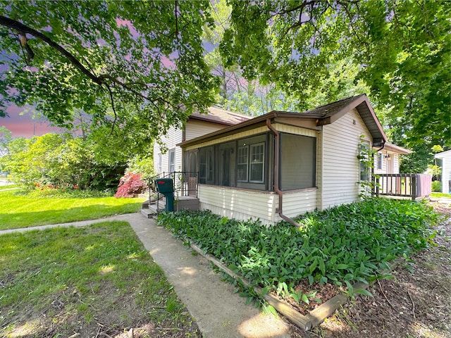 315 E Spruce St, Marshall, MI 49068 - view of side of home with a sunroom and a yard