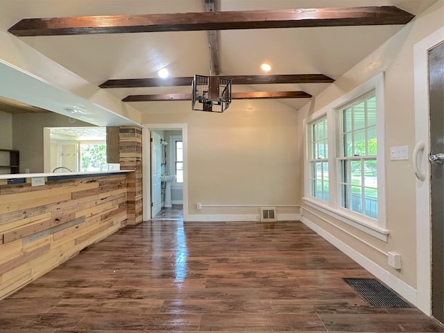 315 E Spruce St, Marshall, MI 49068 - unfurnished living room with a chandelier, dark wood-style floors, and baseboards