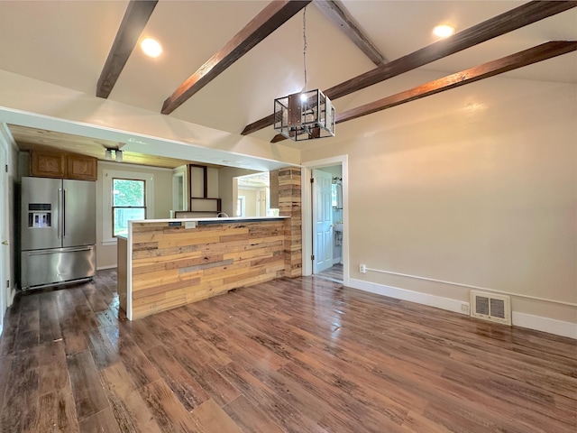315 E Spruce St, Marshall, MI 49068 - kitchen featuring stainless steel fridge, dark wood-type flooring, brown cabinetry, a chandelier, and a peninsula
